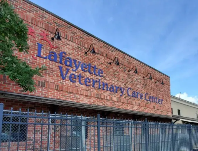 Front view of brick building with Lafayette Veterinary Care Center in large blue letters. 